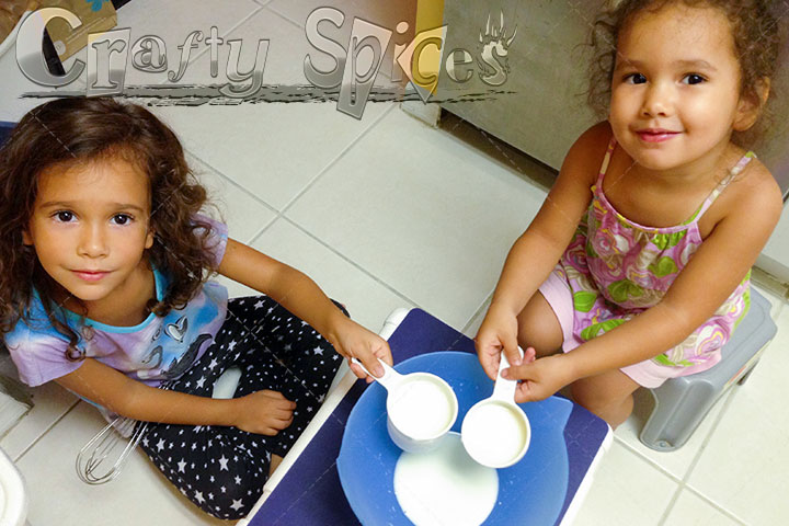 Kira and Kaylle learning about measuring using mesuring cups